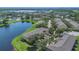 Beautiful aerial view of complex by a pond, with manicured lawns and mature trees at 13480 Applerose Ln # 19, Orlando, FL 32824
