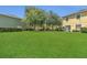 Spacious backyard with lush lawn, mature trees, and a well maintained lawn at 13480 Applerose Ln # 19, Orlando, FL 32824