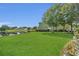 Expansive backyard with mature trees and a serene lake view, perfect for outdoor enjoyment at 13480 Applerose Ln # 19, Orlando, FL 32824