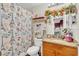 Charming bathroom with Paris themed shower curtain, granite countertop, and decorative accents at 13480 Applerose Ln # 19, Orlando, FL 32824