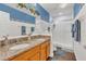 Bathroom featuring double sinks with granite countertops, tiled shower, and stylish accents at 13480 Applerose Ln # 19, Orlando, FL 32824
