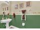 Charming half-bathroom with pedestal sink, decorative wall art, and colorful accents at 13480 Applerose Ln # 19, Orlando, FL 32824