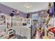 Whimsical bedroom featuring a queen bed, purple color scheme, and decorative accents at 13480 Applerose Ln # 19, Orlando, FL 32824