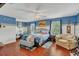 Comfortable bedroom with blue color scheme, natural lighting, and an armchair sitting area at 13480 Applerose Ln # 19, Orlando, FL 32824