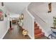 Entryway with wooden floors, staircase, decorative mirror, and plants at 13480 Applerose Ln # 19, Orlando, FL 32824