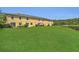 The rear of the property featuring a spacious lawn that runs to the edge of the lake at 13480 Applerose Ln # 19, Orlando, FL 32824
