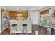 Kitchen with an island, bar stools, wood cabinets, and stainless steel refrigerator at 13480 Applerose Ln # 19, Orlando, FL 32824