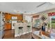 Inviting kitchen with breakfast bar, wood cabinets, and a cozy breakfast nook overlooking the backyard at 13480 Applerose Ln # 19, Orlando, FL 32824