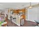 Open kitchen with wooden cabinets, a breakfast bar, and stainless steel appliances at 13480 Applerose Ln # 19, Orlando, FL 32824