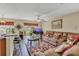Open living room with granite countertops, bar stools, ceiling fan, and a large sofa at 13480 Applerose Ln # 19, Orlando, FL 32824