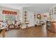 Bright living room with wood-look tile flooring, ample seating, and decorative wall accents at 13480 Applerose Ln # 19, Orlando, FL 32824
