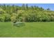 Green picnic table and grill on a large grassy field perfect for outdoor gatherings at 13480 Applerose Ln # 19, Orlando, FL 32824