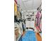 Spacious walk-in closet with organized shelving, hanging racks, and a soft blue rug at 13480 Applerose Ln # 19, Orlando, FL 32824