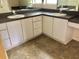 Bathroom vanity with double sinks and tile floor at 144 Costa Mesa Dr, Lady Lake, FL 32159