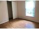 Bedroom featuring laminate flooring, window and closet at 144 Costa Mesa Dr, Lady Lake, FL 32159