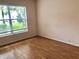 Bedroom with wood floor, bright window, and neutral paint at 144 Costa Mesa Dr, Lady Lake, FL 32159