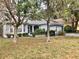 Inviting single-story home with well-maintained landscaping, gray driveway, and attached two-car garage at 144 Costa Mesa Dr, Lady Lake, FL 32159