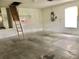 Bright garage featuring concrete flooring, with a ladder and access to additional storage, ideal for organization at 144 Costa Mesa Dr, Lady Lake, FL 32159