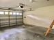 Bright and spacious garage with automatic door and concrete floor, perfect for parking or storage solutions at 144 Costa Mesa Dr, Lady Lake, FL 32159