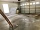 Spacious garage with concrete flooring and an automatic door, providing ample storage and parking space at 144 Costa Mesa Dr, Lady Lake, FL 32159