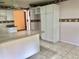 Open kitchen featuring a granite countertop, white cabinets, and tile flooring at 144 Costa Mesa Dr, Lady Lake, FL 32159