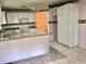 Open kitchen featuring a granite countertop, white cabinets, and tile flooring at 144 Costa Mesa Dr, Lady Lake, FL 32159
