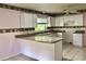 Updated kitchen with ample counter space, tiled floors, white cabinets, and lots of natural light at 144 Costa Mesa Dr, Lady Lake, FL 32159