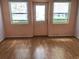 Cozy living room with laminate flooring, natural light, and a glass door at 144 Costa Mesa Dr, Lady Lake, FL 32159