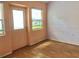 Cozy living room with laminate flooring, natural light, and a glass door at 144 Costa Mesa Dr, Lady Lake, FL 32159