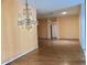 Open living room with wood floors, decorative chandelier and arched doorways leading to other rooms at 144 Costa Mesa Dr, Lady Lake, FL 32159