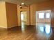 Spacious living room with beautiful wood floors and open doorways for easy movement throughout the home at 144 Costa Mesa Dr, Lady Lake, FL 32159