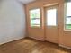 Cozy living room with laminate flooring, natural light, and a glass door at 144 Costa Mesa Dr, Lady Lake, FL 32159