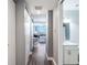 Hallway with wood floors leading to an open living area and bathroom at 150 E Robinson St # 626, Orlando, FL 32801