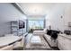 Modern condo living area with large windows, white furniture, and city views at 150 E Robinson St # 626, Orlando, FL 32801