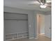 Bedroom featuring a closet with shelving, a ceiling fan, and a tiled floor at 1505 W Lake Cannon Nw Dr, Winter Haven, FL 33881