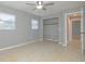 Bedroom with a ceiling fan, a closet with shelving, and a tiled floor at 1505 W Lake Cannon Nw Dr, Winter Haven, FL 33881