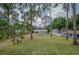 Charming single-story home with a spacious green lawn and mature trees creating a serene setting at 1505 W Lake Cannon Nw Dr, Winter Haven, FL 33881