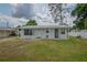 Charming single-story home with a fresh exterior paint and a well-manicured lawn and white fence at 1505 W Lake Cannon Nw Dr, Winter Haven, FL 33881