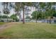 Lovely single-story home with a lush green lawn and mature trees providing shade and character at 1505 W Lake Cannon Nw Dr, Winter Haven, FL 33881