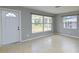 Inviting living room with neutral paint, a front door, and windows at 1505 W Lake Cannon Nw Dr, Winter Haven, FL 33881