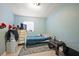 A furnished bedroom with tile floors features a dresser, bed, window, and dark wooden table at 1508 Roger Babson Rd, Orlando, FL 32808