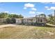 Charming single-story home featuring a cozy front porch and a well-maintained lawn with large driveway at 1508 Roger Babson Rd, Orlando, FL 32808
