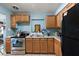 Traditional kitchen with stainless steel appliances, granite countertops, and wooden cabinets at 1508 Roger Babson Rd, Orlando, FL 32808
