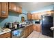 Well-lit kitchen with stainless steel appliances and wooden cabinets at 1508 Roger Babson Rd, Orlando, FL 32808