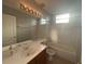 Bathroom equipped with large mirror, vanity, bathtub, and toilet exuding comfort at 151 Prestwick Dr, Davenport, FL 33897