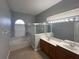 Bathroom showcasing double vanity, bathtub, and frameless glass shower with natural lighting at 151 Prestwick Dr, Davenport, FL 33897