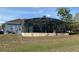 Exterior view of screened pool and patio with tropical foliage, perfect for outdoor enjoyment at 151 Prestwick Dr, Davenport, FL 33897