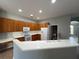 Bright kitchen with white countertops, wooden cabinets, and essential appliances for cooking and entertaining at 151 Prestwick Dr, Davenport, FL 33897