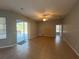 Expansive living room with tile flooring and sliding glass door leading to an outdoor patio area at 151 Prestwick Dr, Davenport, FL 33897