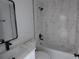 Bright bathroom highlighting a shower-tub combo and modern vanity at 16648 Sw 25Th Ct, Ocala, FL 34473
